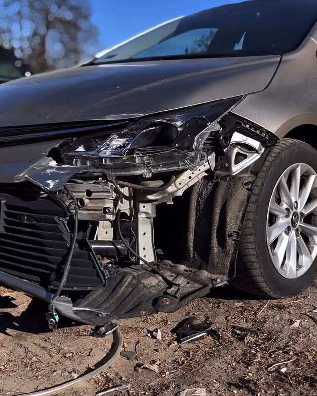 Beżowa Toyota Corolla z rozbitym lewym przodem: urwany zderzak, pęknięty reflektor, odsłonięte wnętrze nadkola